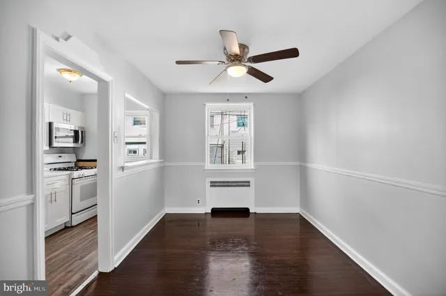 a view of a kitchen with a white cabinet and a stove top oven