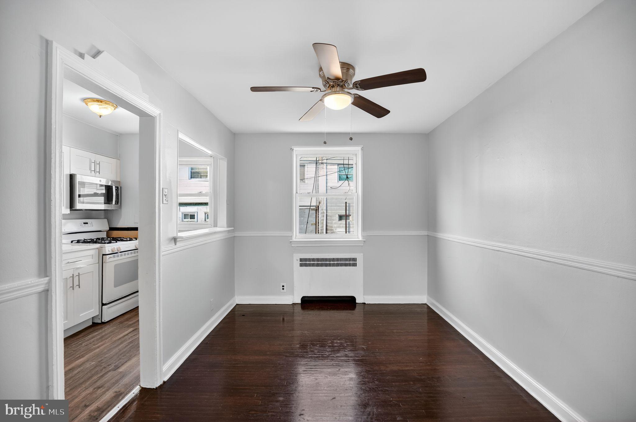 558 Snowden Road Upper Darby, PA 19082 - Photo 6 of 30 a view of a kitchen with a white cabinet and a stove top oven