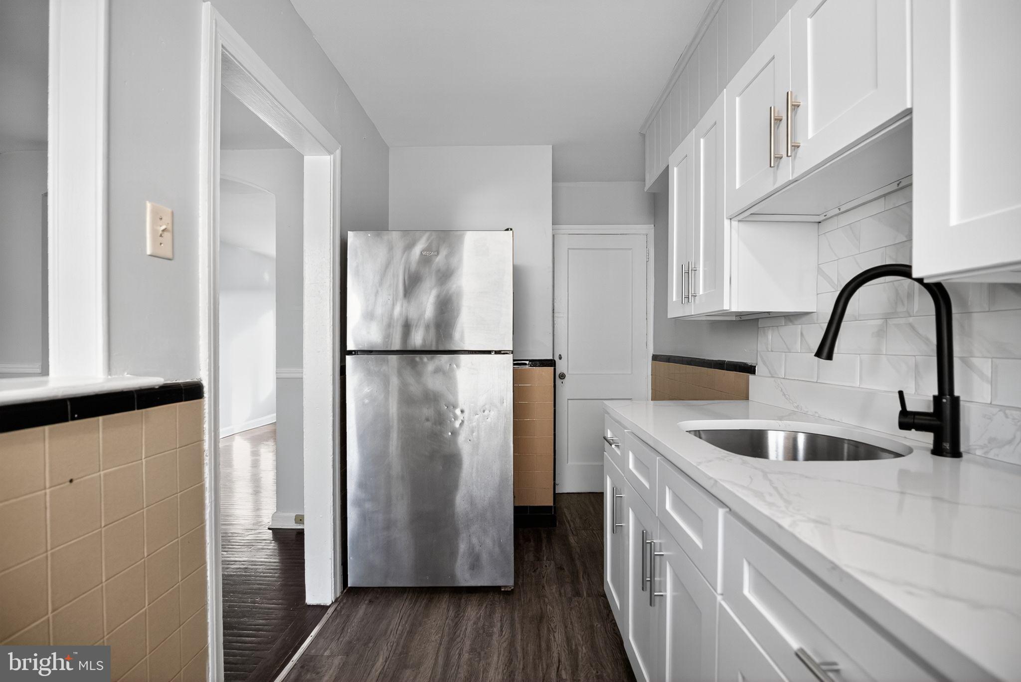 558 Snowden Road Upper Darby, PA 19082 - Photo 8 of 30 a kitchen with a refrigerator and a sink