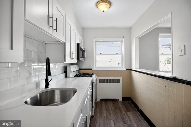 a kitchen with a sink and a refrigerator