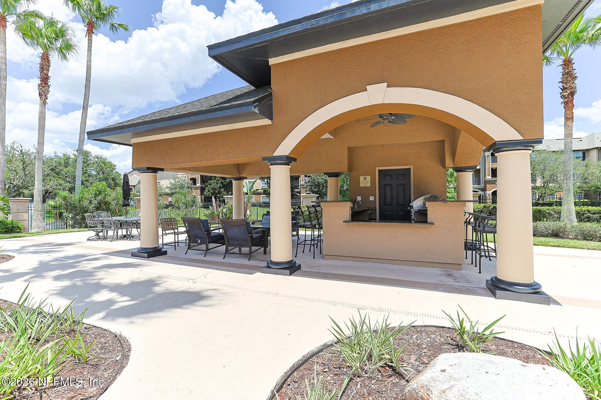 10961 Burnt Mill Road, Unit 426 Jacksonville, FL 32256 - Photo 18 of 24 a view of a building with sitting area