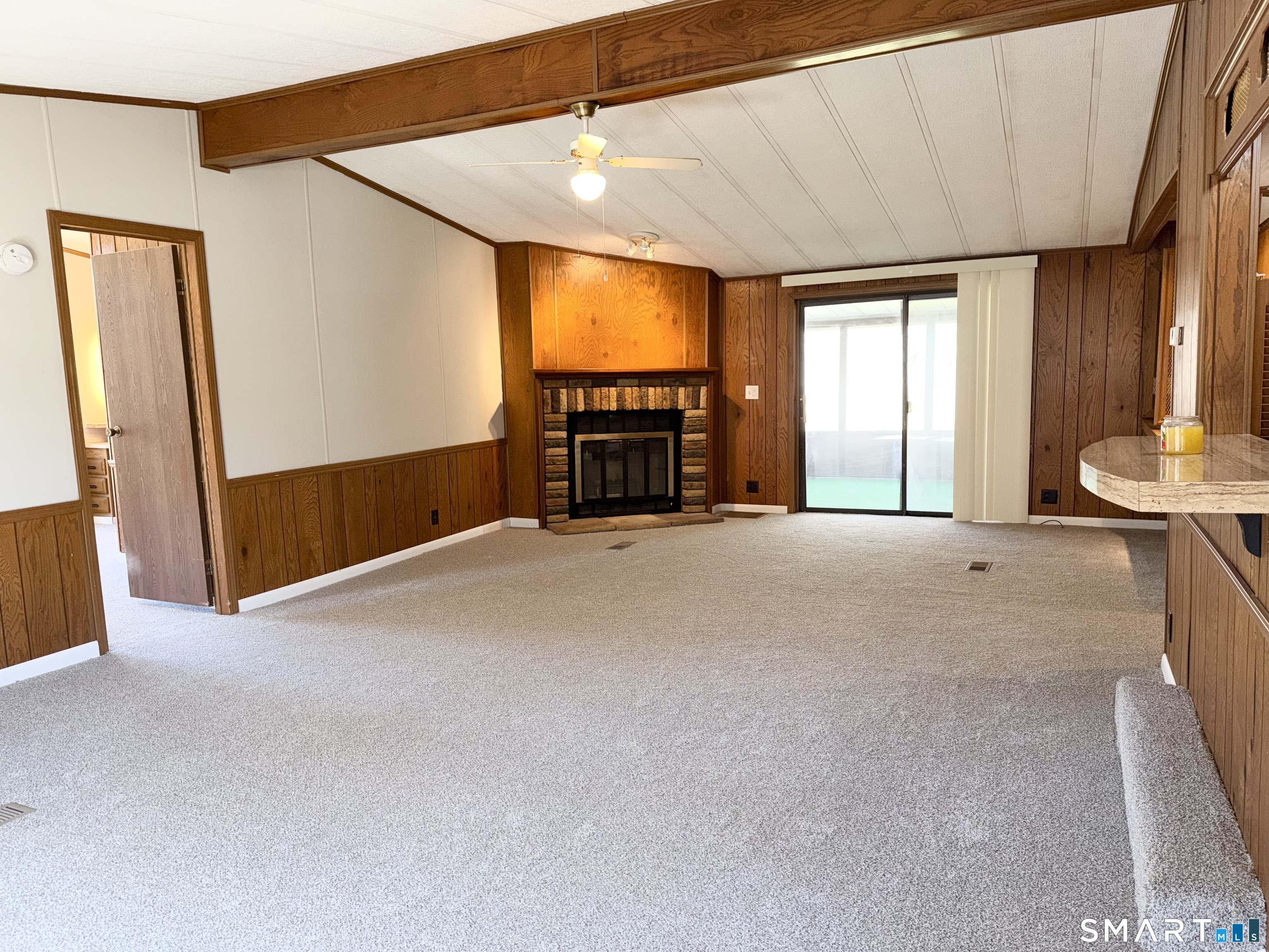 65 Colchester Cmns Colchester, CT 06415 - Photo 8 of 74 a view of an empty room with a fireplace and a window