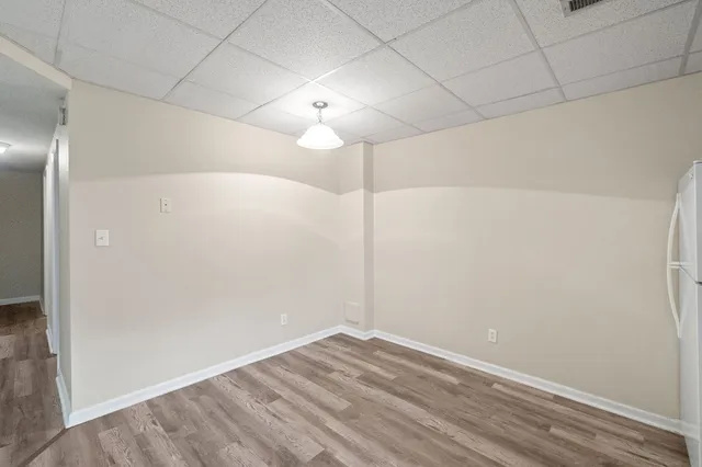 a view of a room with wooden floor