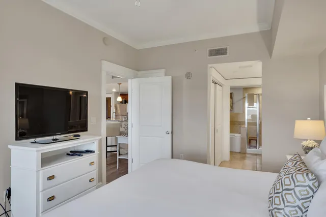 a bedroom with a flat screen tv and a bed