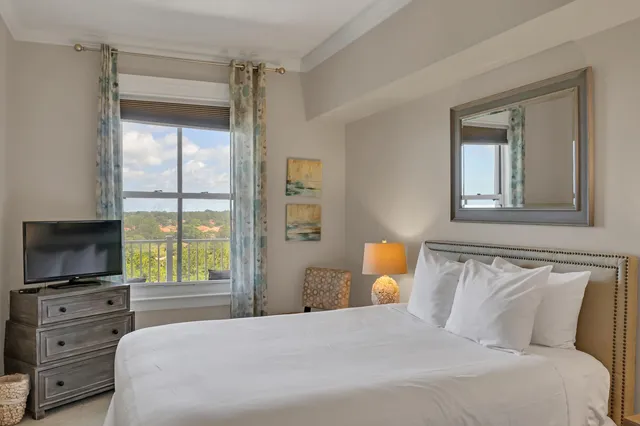 a bedroom with a bed and flat screen tv