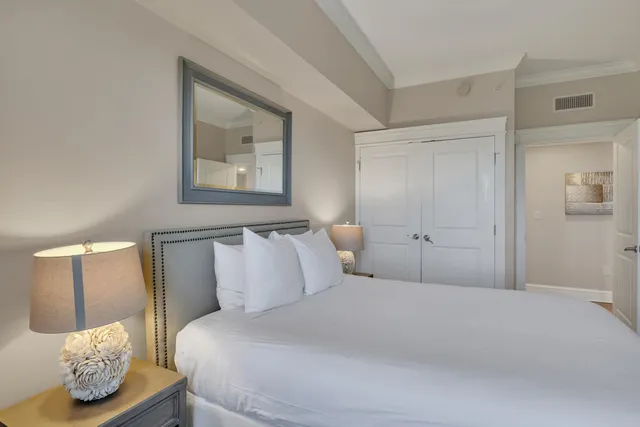 a bedroom with a bed and a mirror