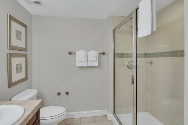 a white toilet sitting next to a bathroom sink