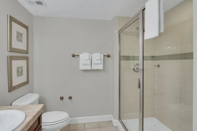 a white toilet sitting next to a bathroom sink