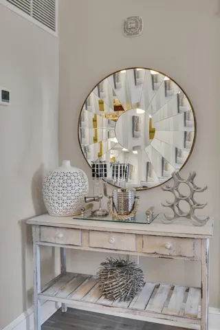 a bathroom with a small white and a white rack on the wall