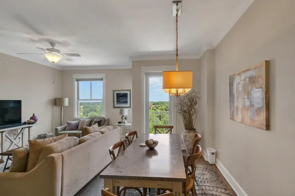 a living room with furniture a window and a flat screen tv