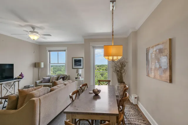 a living room with furniture a window and a flat screen tv
