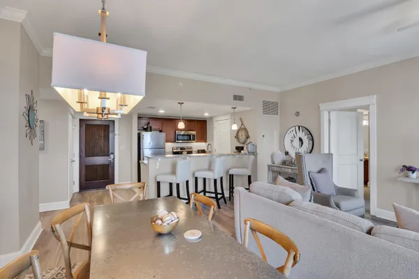 a living room with kitchen island furniture and a chandelier