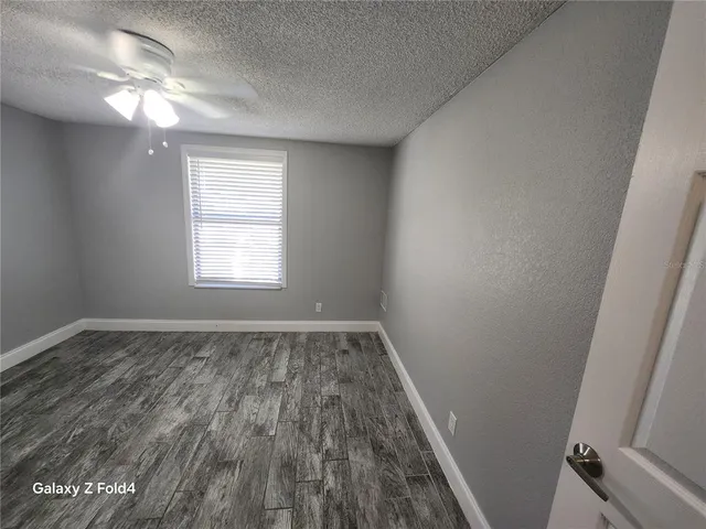 a view of a room with wooden floor and window