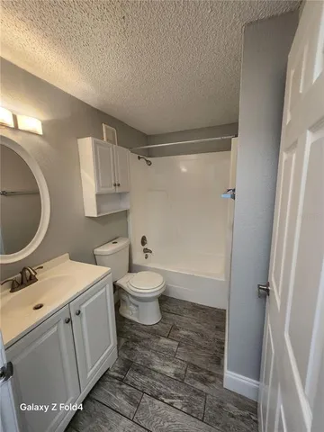 a bathroom with a sink mirror vanity and toilet