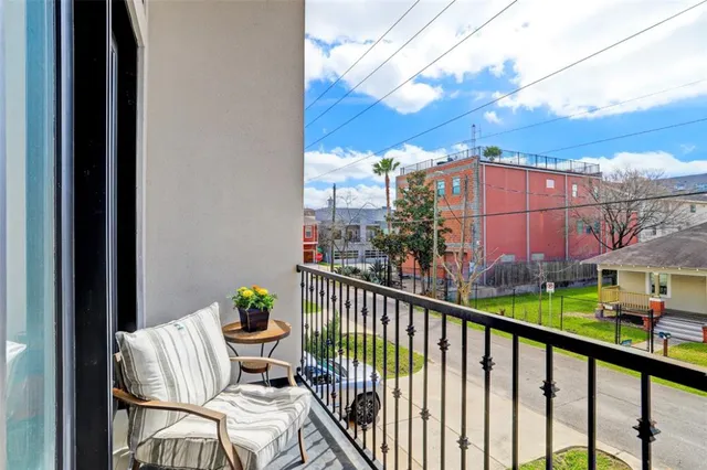 a kitchen with stainless steel appliances granite countertop a dining table chairs refrigerator and sink