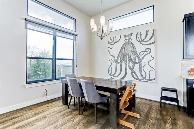 a kitchen with a stove a sink a refrigerator and wooden floor