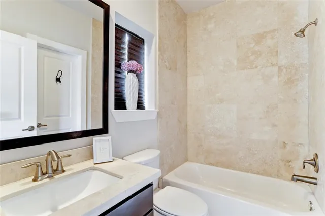 a view of a room with wooden floor closet and ceiling fan