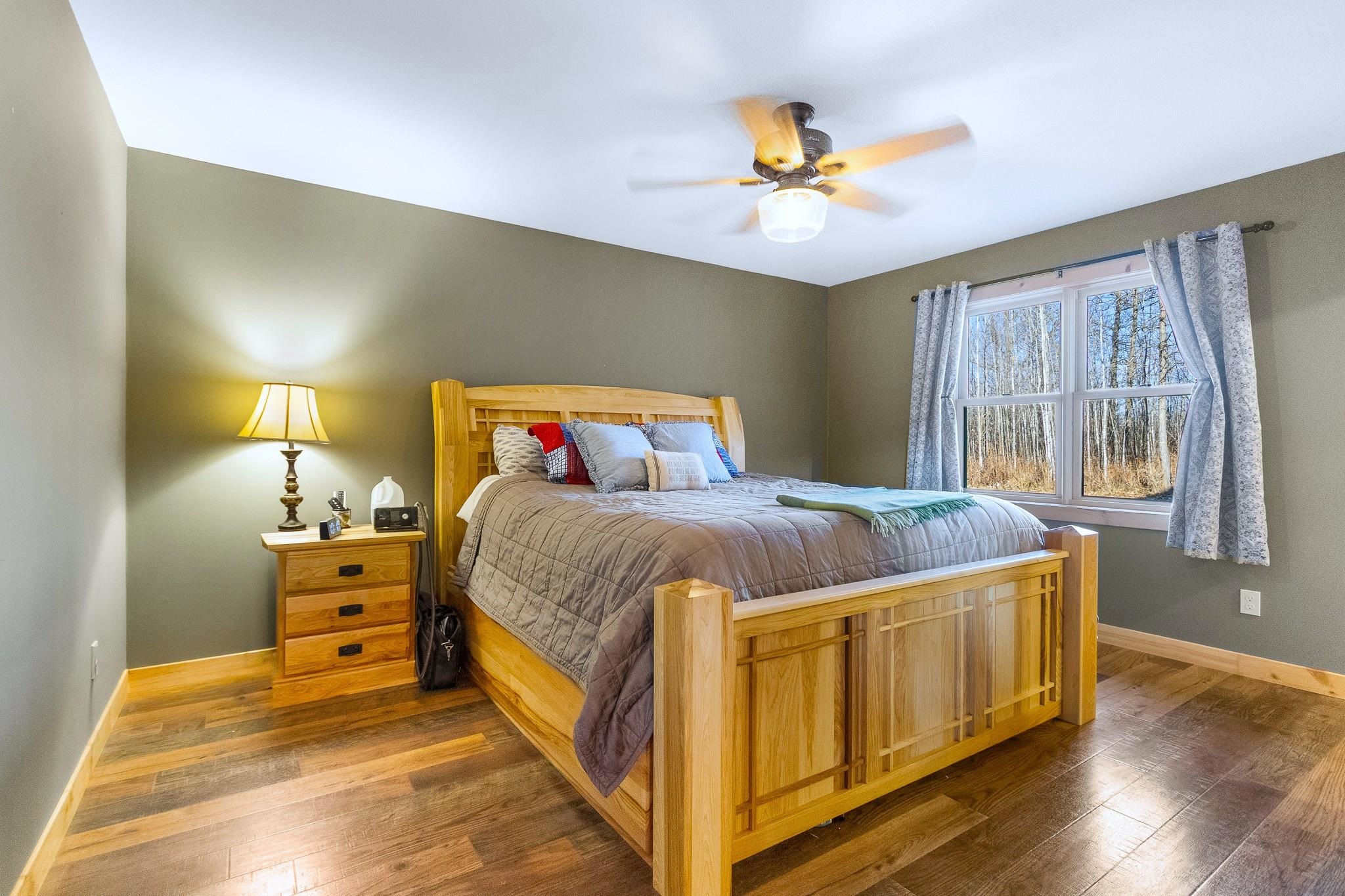 6014 Brown Road Kettle River, MN 55757 - Photo 16 of 54 Bedroom featuring wood-type flooring and a ceiling fan