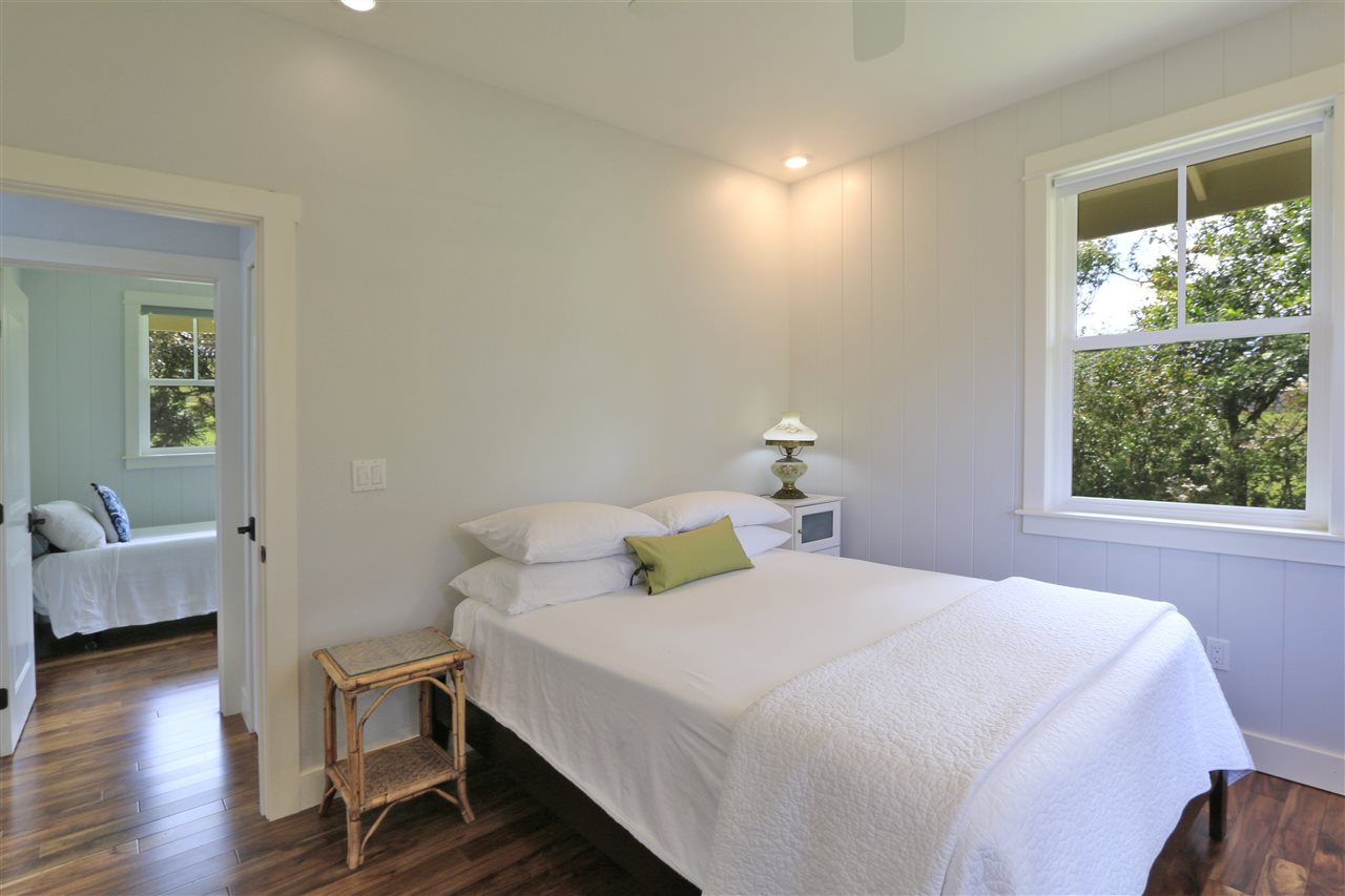 2736 Kaupakalua Road Haiku, HI 96708 - Photo 19 of 30 a bedroom with a bed and wooden floor