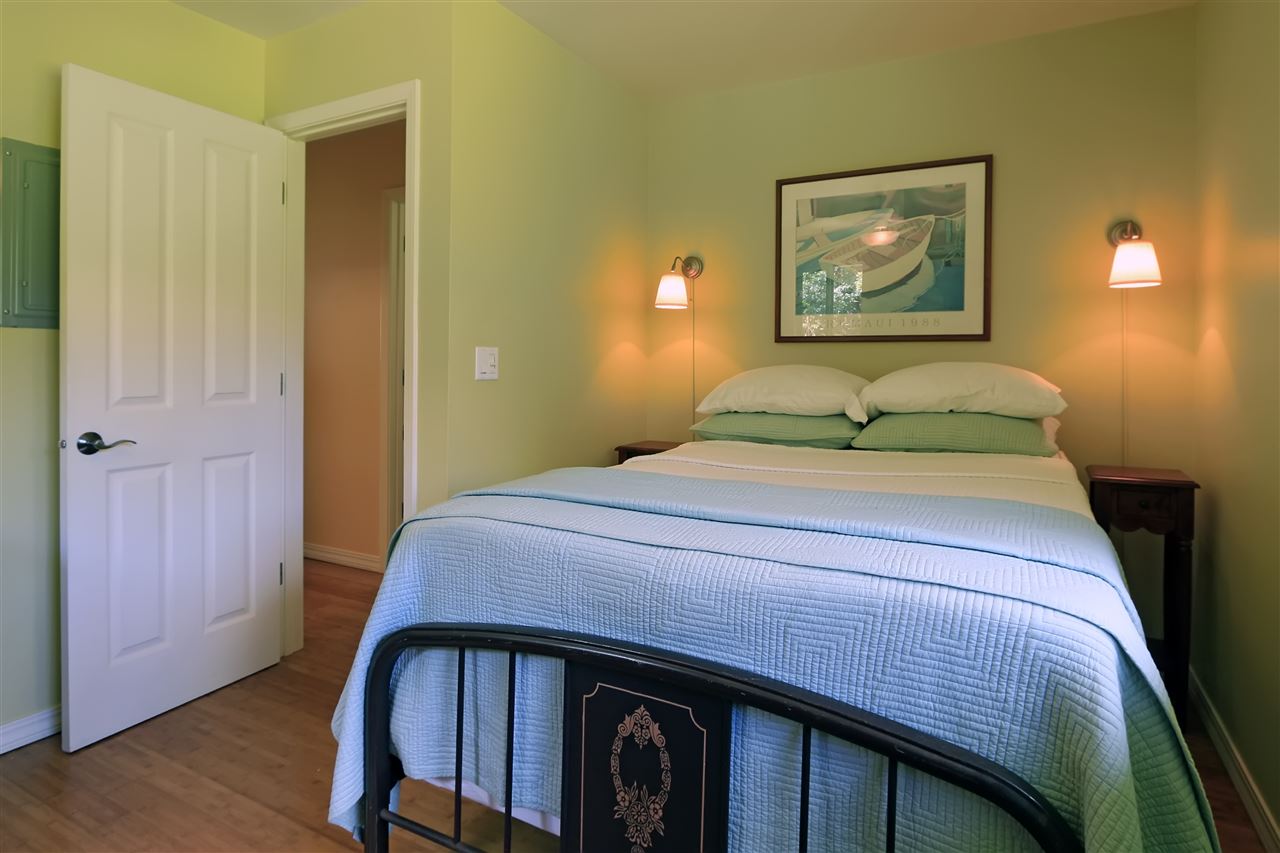 2736 Kaupakalua Road Haiku, HI 96708 - Photo 26 of 30 a bedroom with a bed and wooden floor
