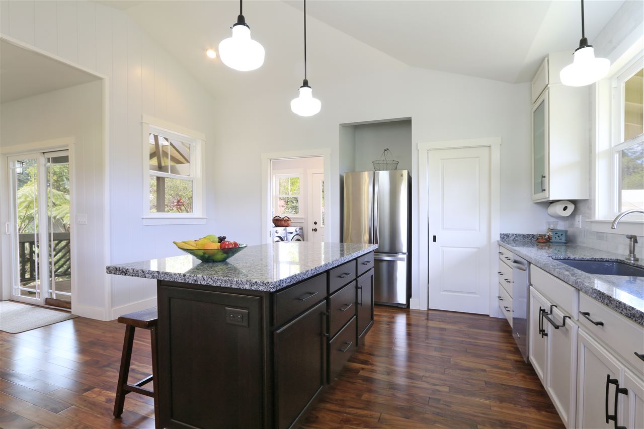 2736 Kaupakalua Road Haiku, HI 96708 - Photo 6 of 30 a kitchen with stainless steel appliances granite countertop a sink stove and wooden floor