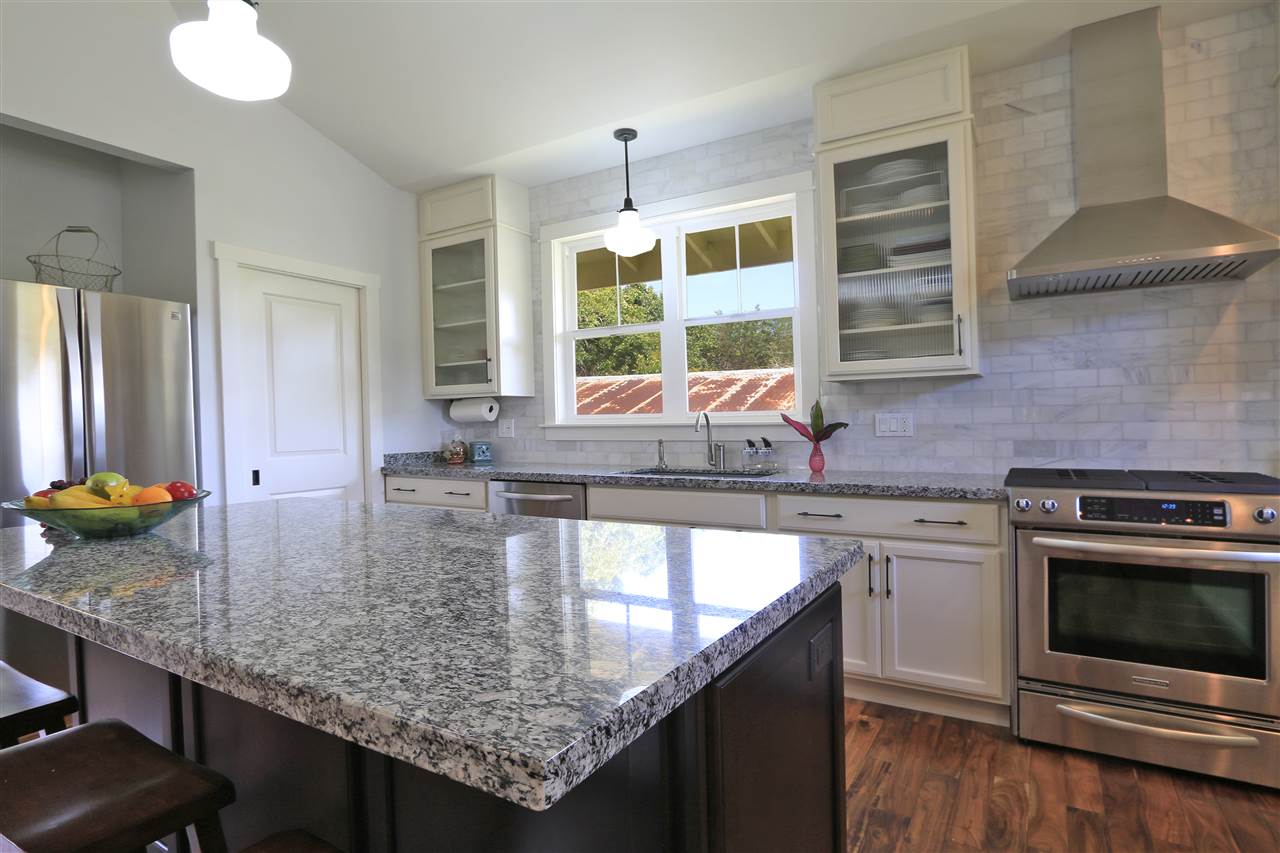 2736 Kaupakalua Road Haiku, HI 96708 - Photo 7 of 30 a kitchen with kitchen island granite countertop a stove and a sink