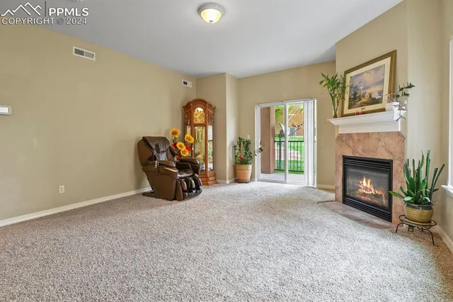 a view of a kitchen counter top space with furniture and a fireplace