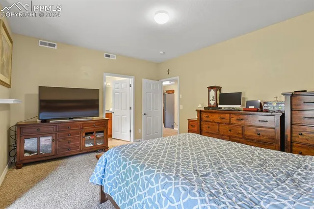 a bathroom with a granite countertop sink toilet mirror and shower