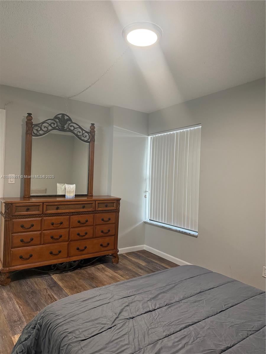 1627 Riverview Road, Unit 212 Deerfield Beach, FL 33441 - Photo 11 of 27 a bedroom with a bed and a mirror on dresser