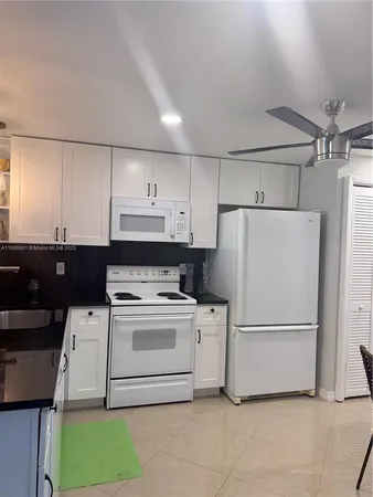 a white refrigerator freezer sitting in a kitchen