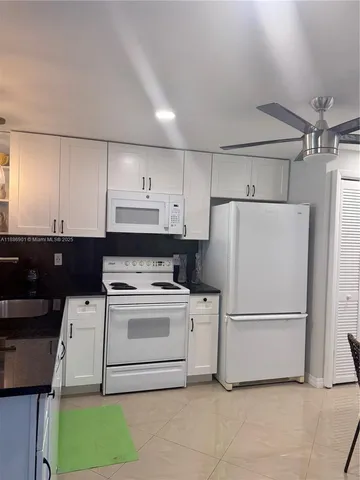 a white refrigerator freezer sitting in a kitchen