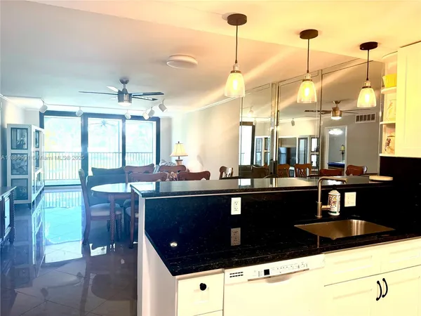 a kitchen with a refrigerator and wooden cabinets