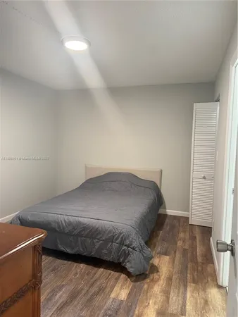 a room with a wooden floor and a window