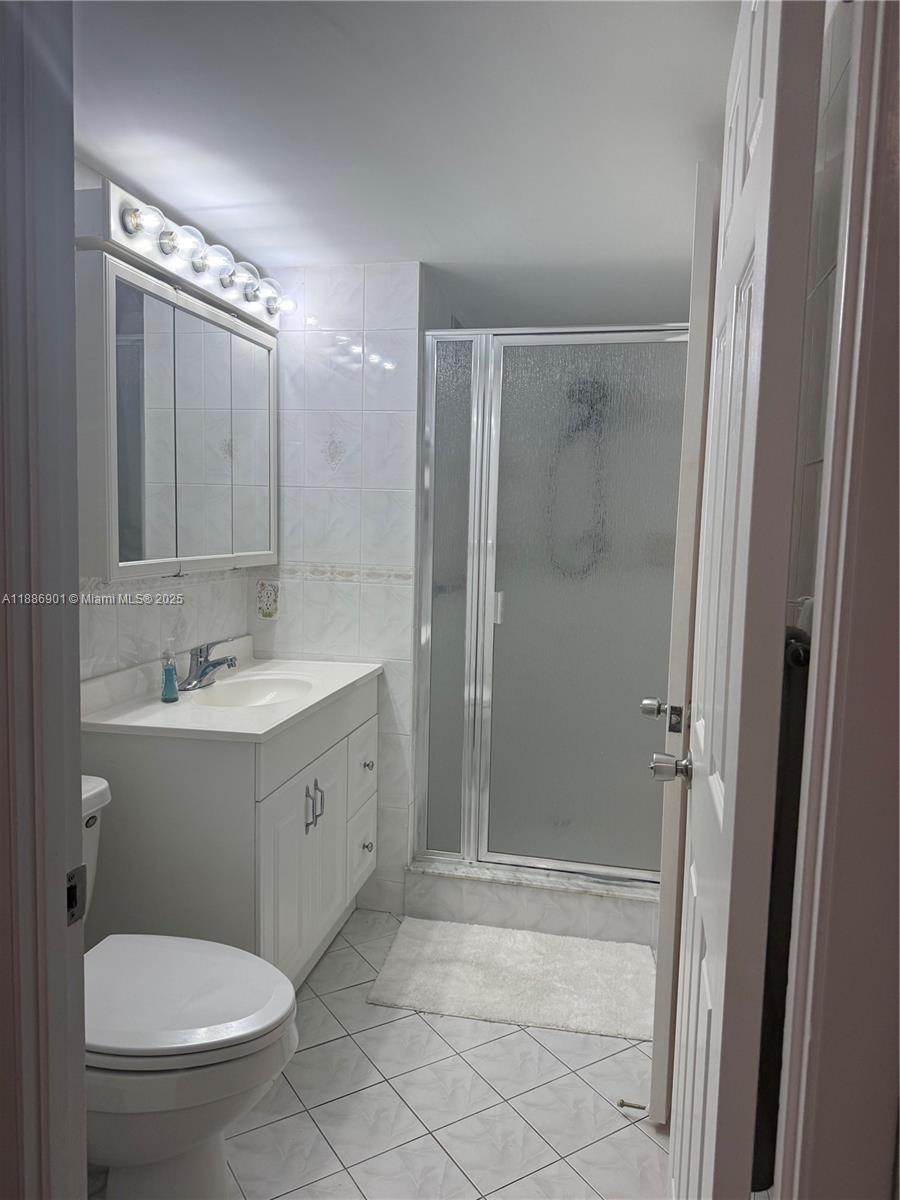 1627 Riverview Road, Unit 212 Deerfield Beach, FL 33441 - Photo 10 of 27 a bathroom with a toilet a sink and shower