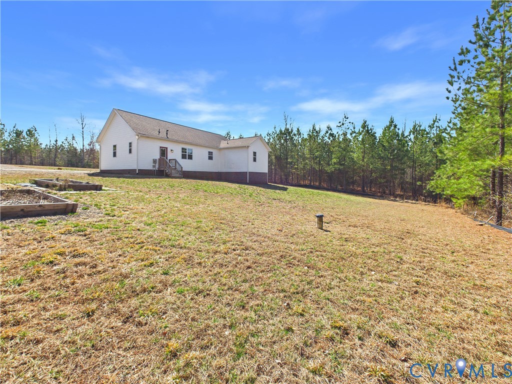 6795 Darlington Heights Road Cullen, VA 23934 - Photo 42 of 44 Rear view of house with a garden, a yard, and a wo