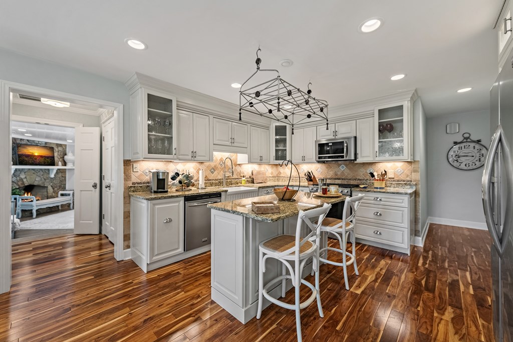 223 Mountain Tops Road Blue Ridge, GA 30513 - Photo 20 of 80 a kitchen with stainless steel appliances kitchen island granite countertop a table and chairs in it