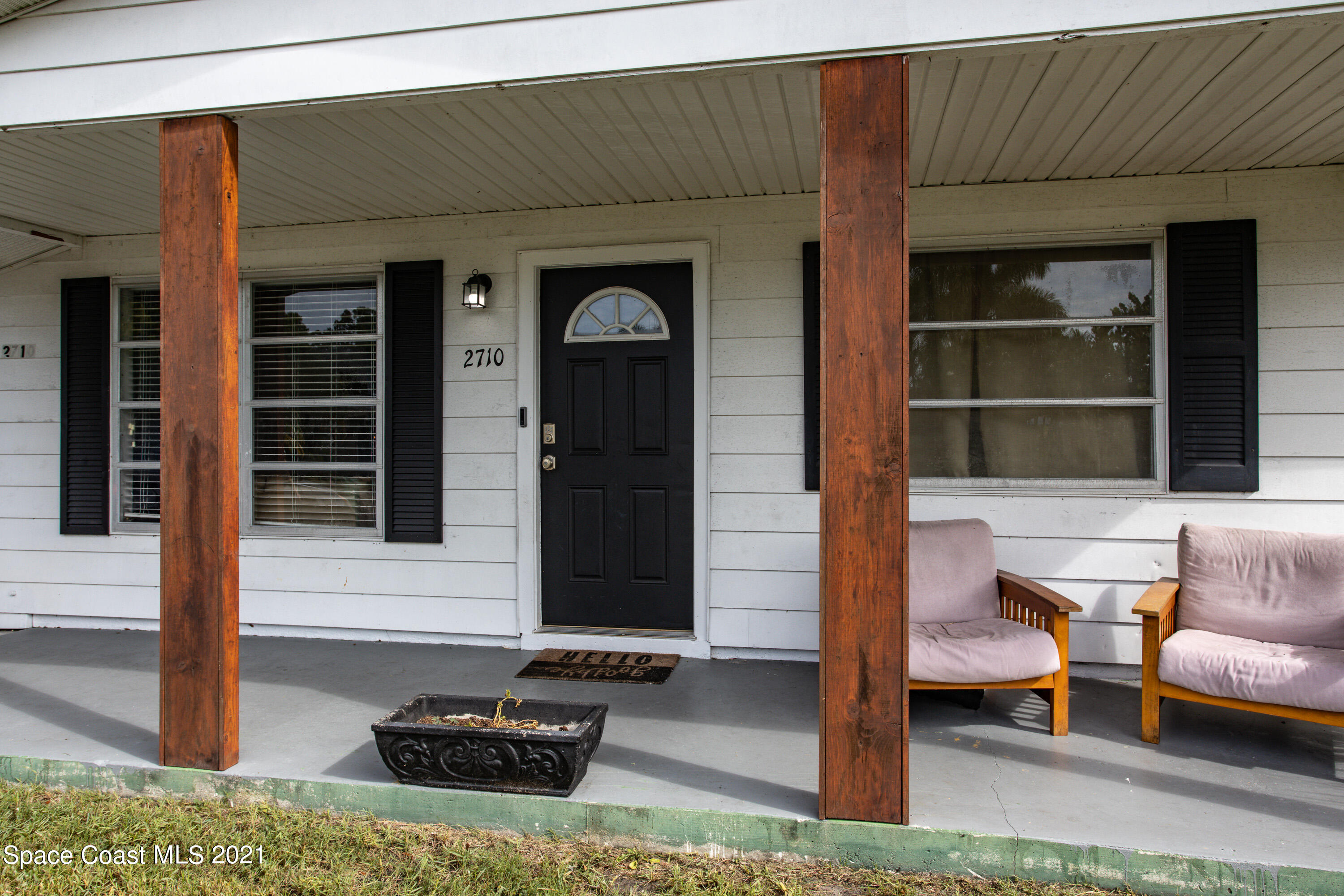 2710 King Richard Road Melbourne, FL 32935 - Photo 3 of 17 a front view of a house with outdoor seating