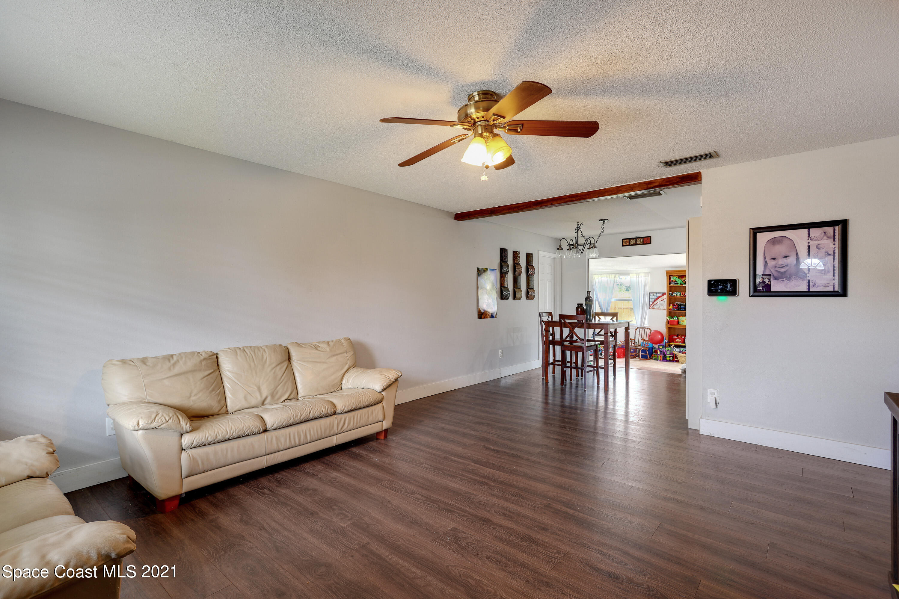 2710 King Richard Road Melbourne, FL 32935 - Photo 5 of 17 a living room with furniture and a wooden floor