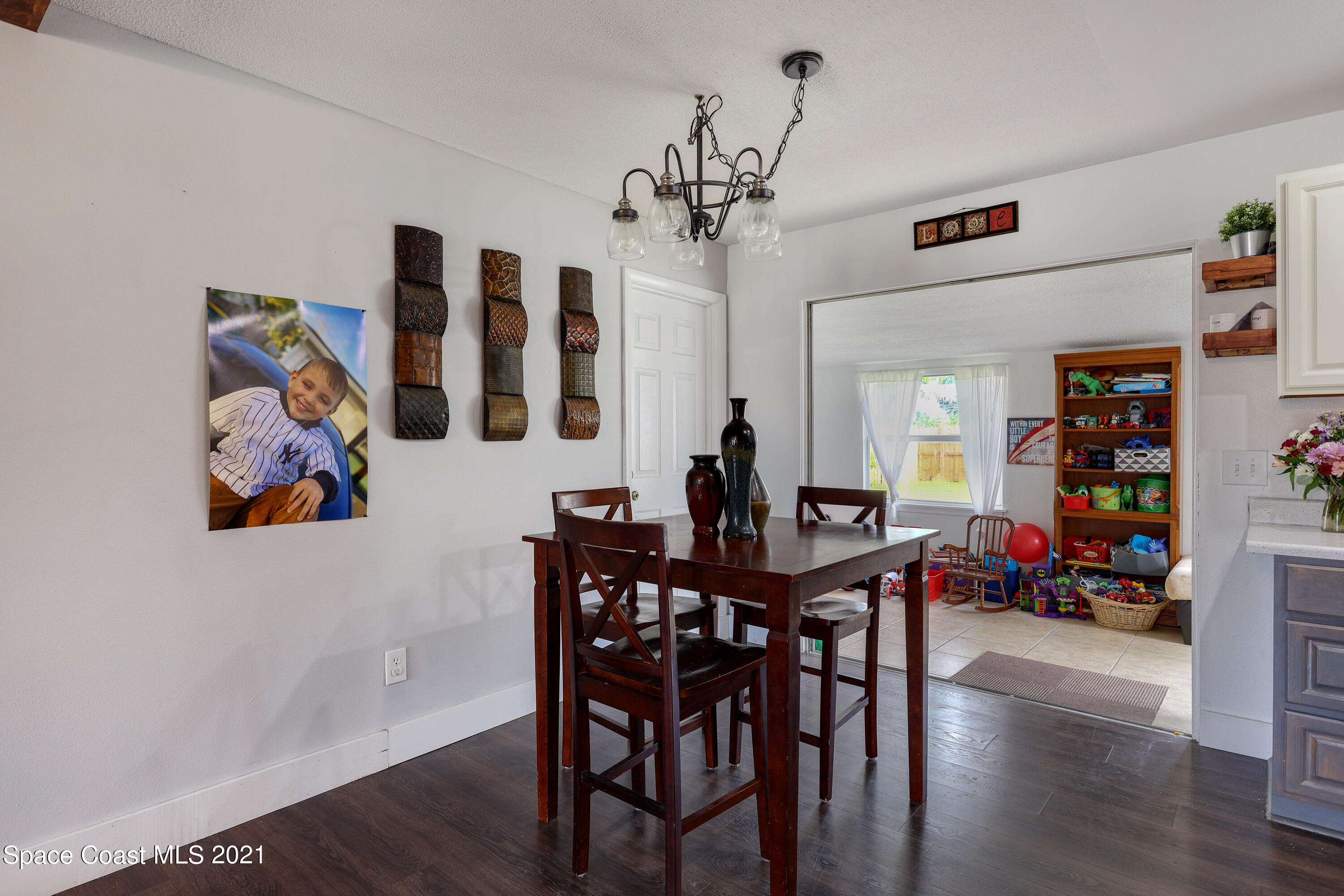 2710 King Richard Road Melbourne, FL 32935 - Photo 6 of 17 a view of a dining room with furniture and wooden floor