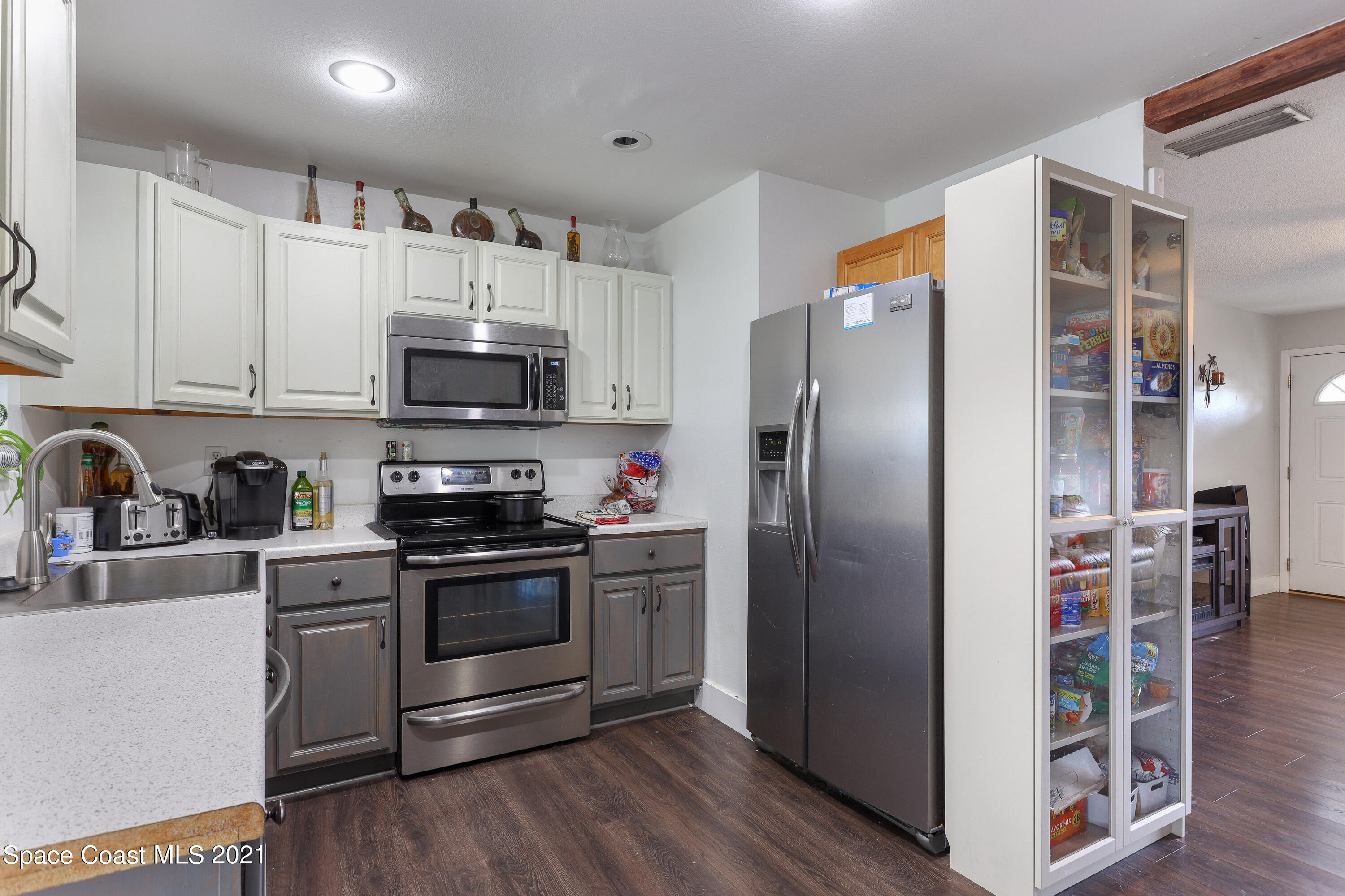 2710 King Richard Road Melbourne, FL 32935 - Photo 8 of 17 a kitchen with stainless steel appliances granite countertop a refrigerator stove and sink