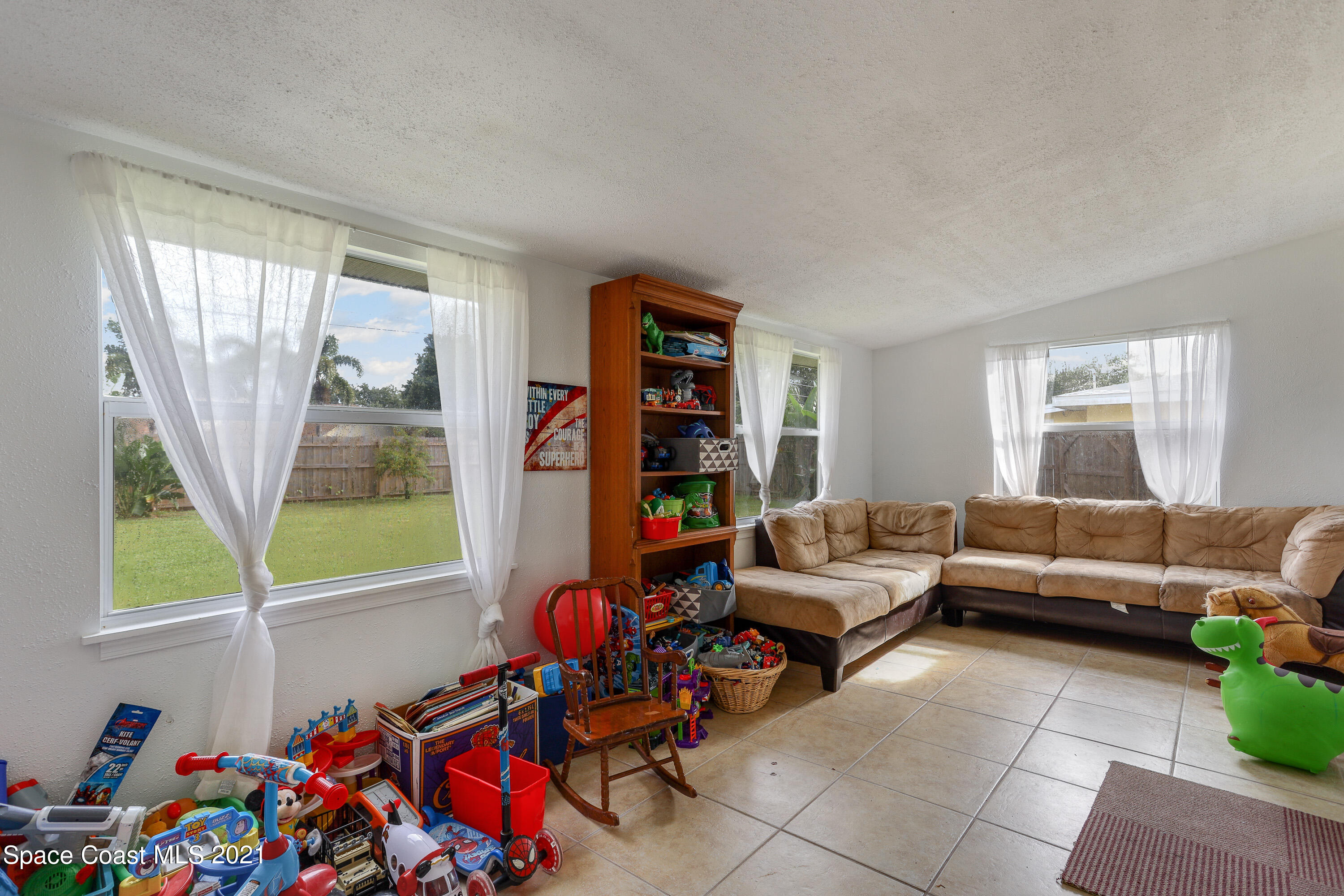 2710 King Richard Road Melbourne, FL 32935 - Photo 10 of 17 a living room with furniture and a window