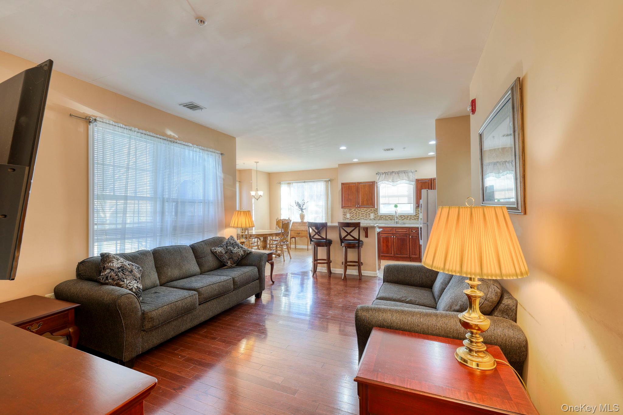 927 Tower Ridge Circle Middletown, NY 10941 - Photo 11 of 36 Living area with dark wood finished floors and recessed lighting
