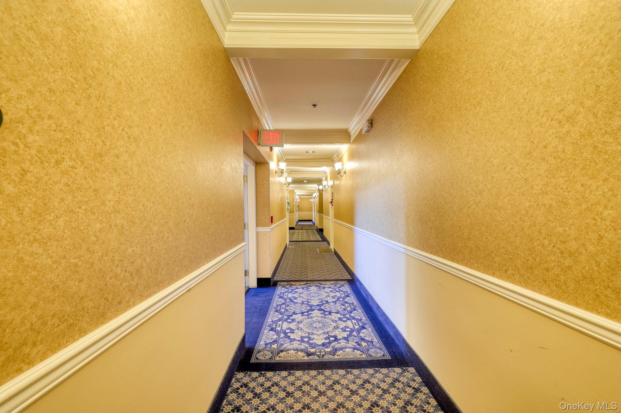 927 Tower Ridge Circle Middletown, NY 10941 - Photo 8 of 36 Hallway featuring wainscoting, crown molding, dark carpet, and a textured wall