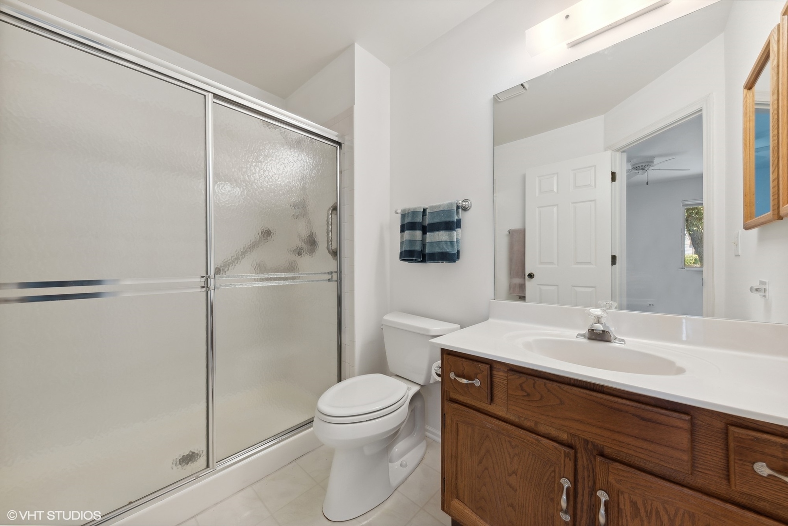 1406 Aldgate Court, Unit D1 Wheeling, IL 60090 - Photo 11 of 16 a bathroom with a sink toilet and shower