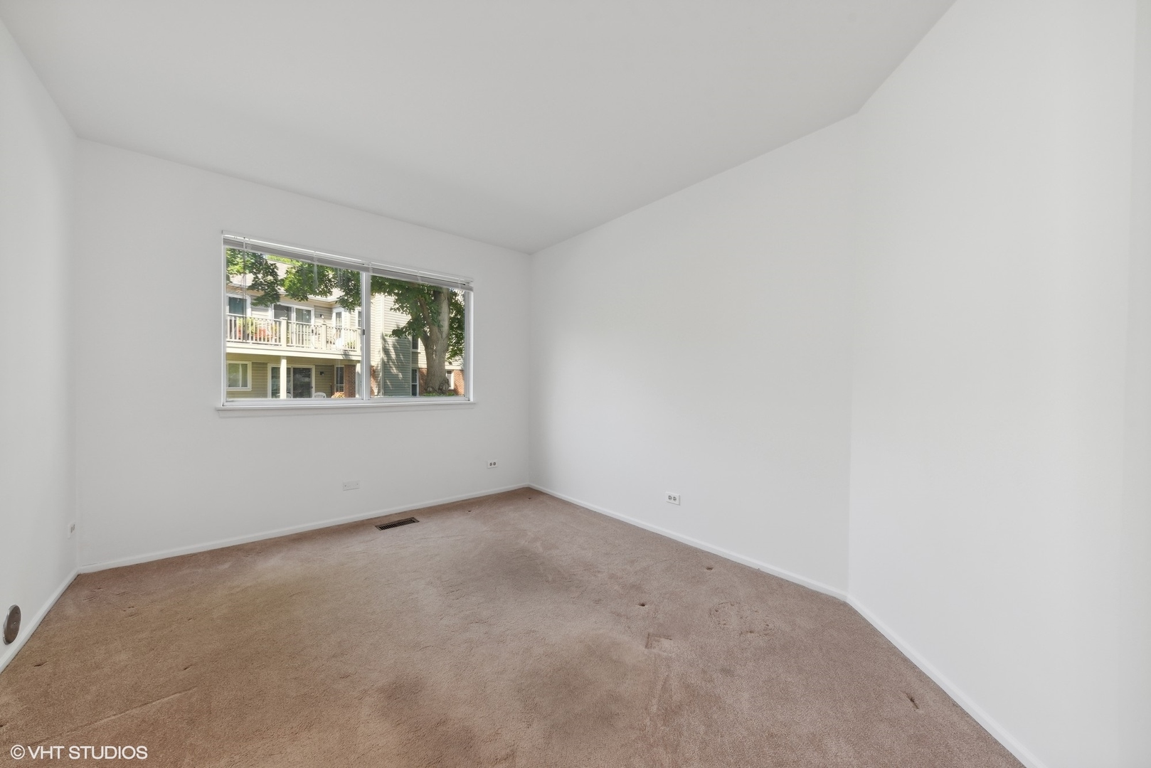 1406 Aldgate Court, Unit D1 Wheeling, IL 60090 - Photo 13 of 16 an empty room with windows