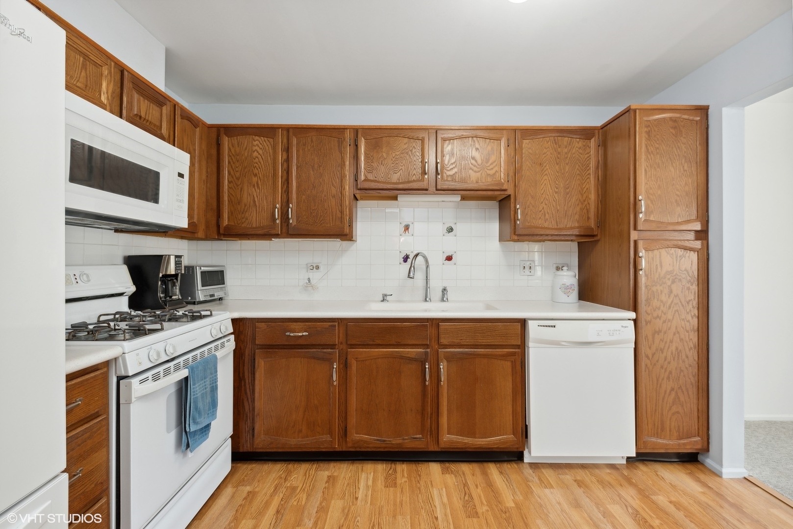 1406 Aldgate Court, Unit D1 Wheeling, IL 60090 - Photo 5 of 16 a kitchen with stainless steel appliances granite countertop a stove a sink and a refrigerator