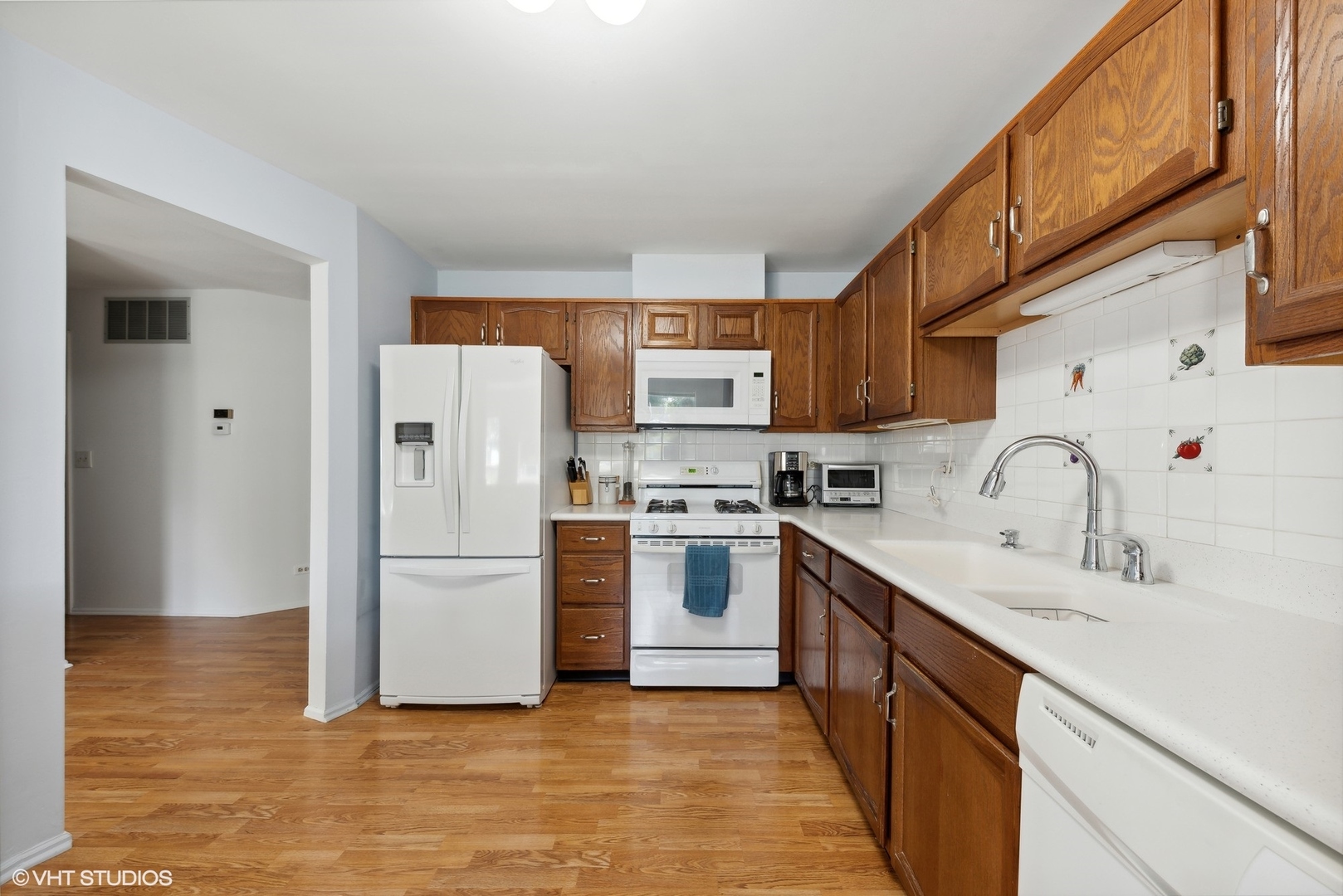 1406 Aldgate Court, Unit D1 Wheeling, IL 60090 - Photo 6 of 16 a kitchen with stainless steel appliances granite countertop a refrigerator sink and cabinets