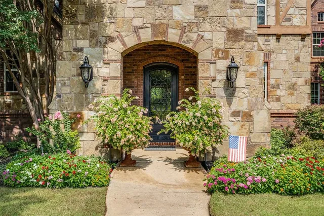 a front view of a house with a garden