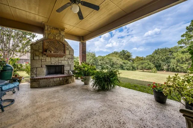 a front view of a house with a garden and trees