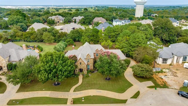 an aerial view of a house with a yard and garden